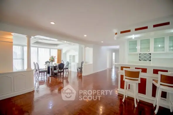 Spacious open-plan living and dining area with elegant hardwood floors and ample natural light.