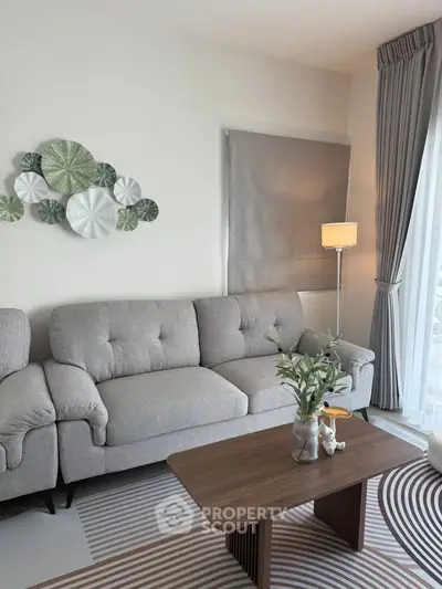 Stylish living room with modern gray sofa and elegant decor