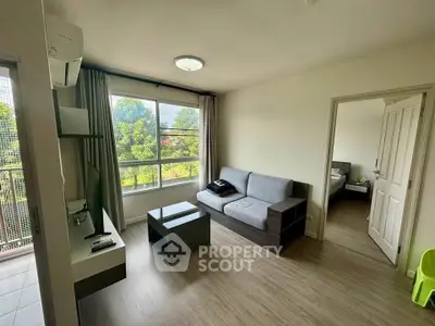 Modern living room with large window and cozy sofa in a bright apartment