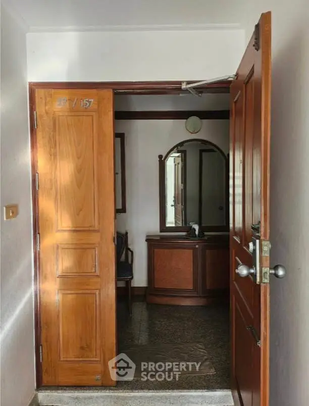 Inviting entrance to a cozy interior space with wooden door and elegant decor.