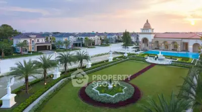 Luxurious estate with manicured gardens and elegant architecture at sunset.