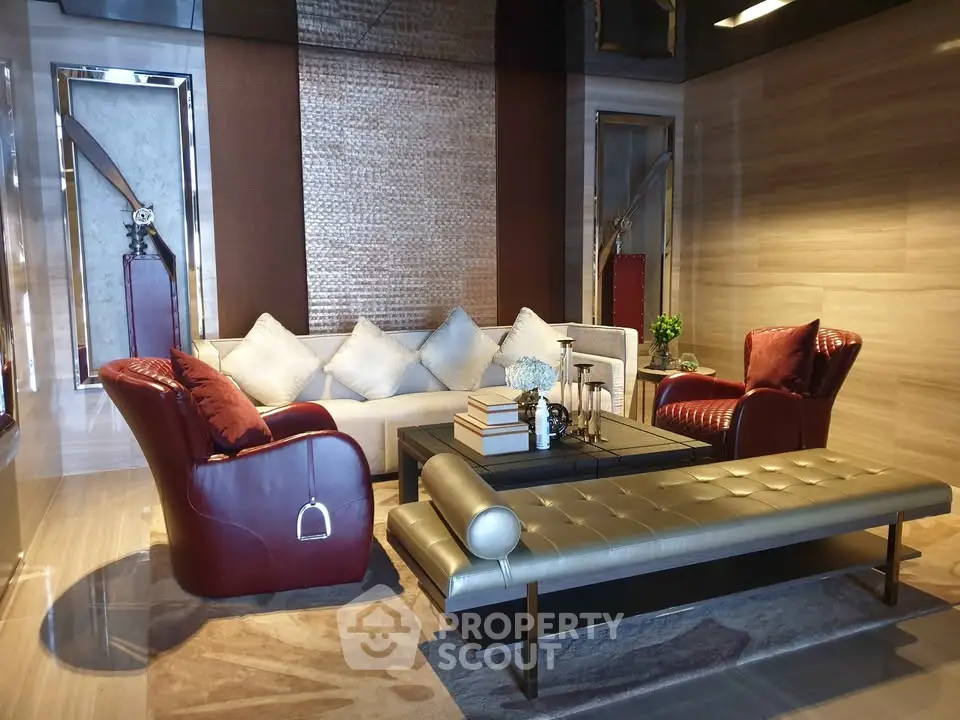Luxurious modern living room with elegant red leather chairs and stylish decor.