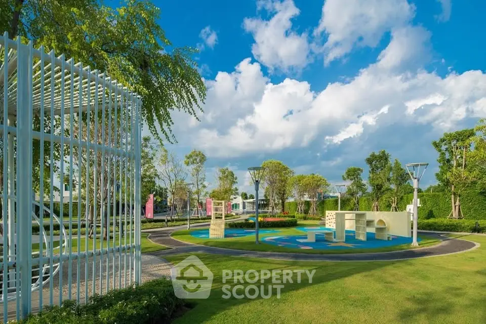 Beautifully landscaped garden with modern outdoor seating and lush greenery under a clear blue sky.
