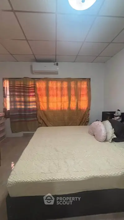 Cozy bedroom with air conditioning and warm lighting, perfect for relaxation.