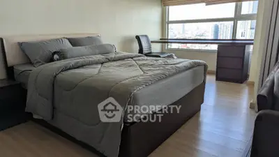 Spacious bedroom with city view and modern furnishings