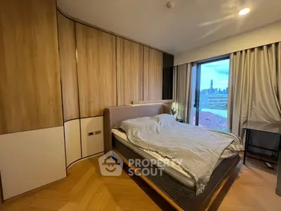 Modern bedroom with city view, featuring stylish wood paneling and large windows for natural light.