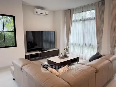 Modern living room with large TV and elegant sofa set