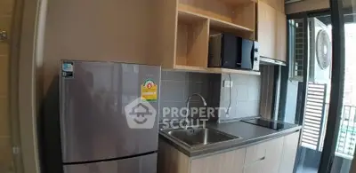 Modern kitchen with sleek appliances and open shelving in a stylish apartment.