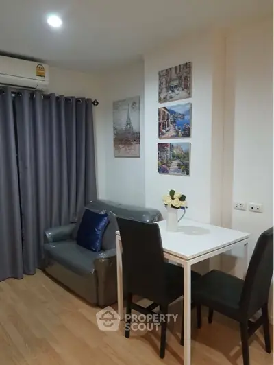 Cozy and inviting living space with comfortable seating, elegant dining set, and charming wall art, perfect for relaxation and social gatherings.