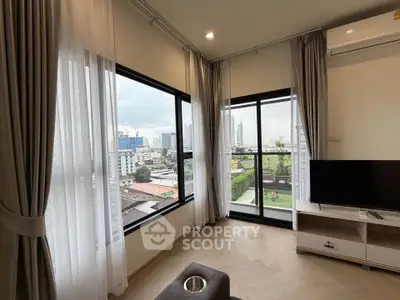 Modern living room with large windows and city view, featuring stylish curtains and air conditioning.