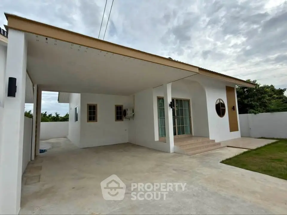 Charming single-story home with covered carport and lush green lawn, perfect for family living.