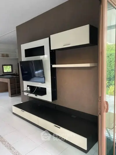 Modern living room with sleek TV unit and open layout, perfect for contemporary living.