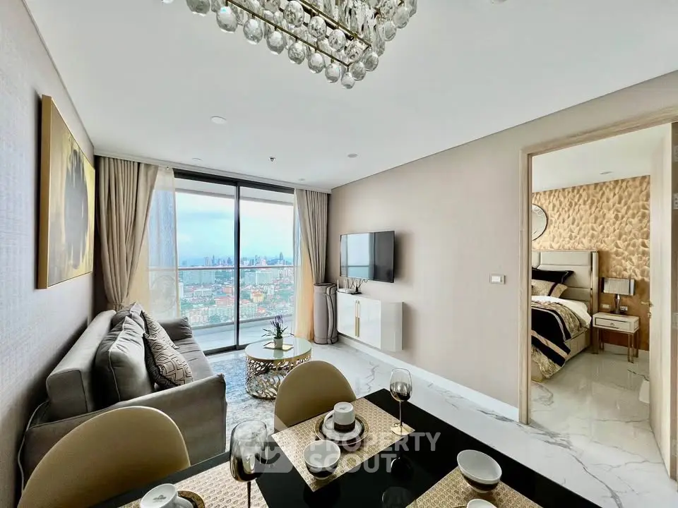 Luxurious modern living room with city view, elegant decor, and open dining area in high-rise apartment.
