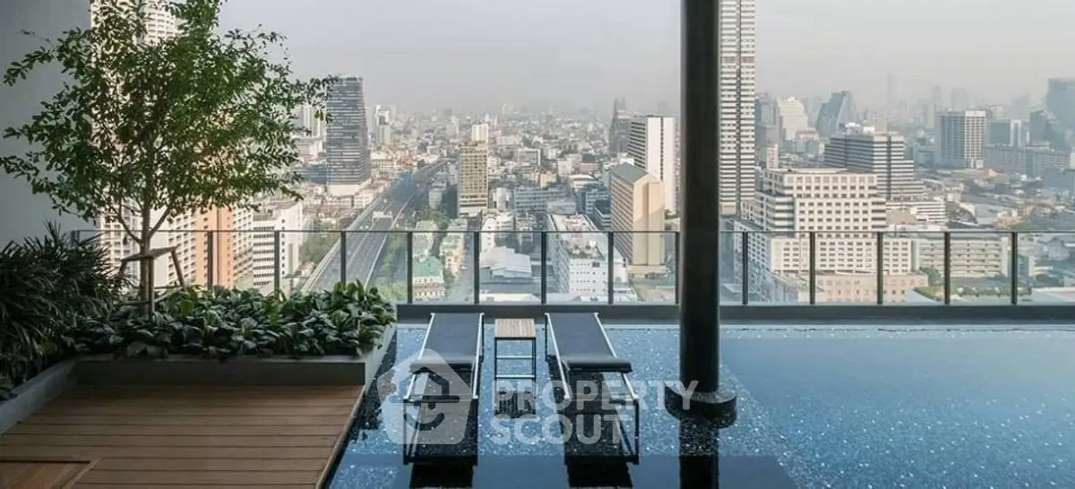 Stunning rooftop pool with panoramic city skyline view, perfect for luxury urban living.