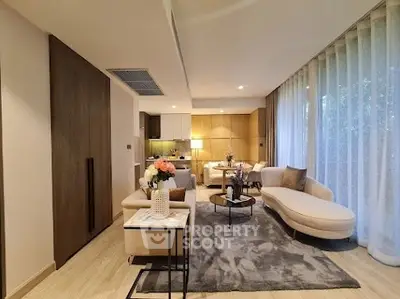 Luxurious open-plan living room with elegant decor and large windows for natural light.