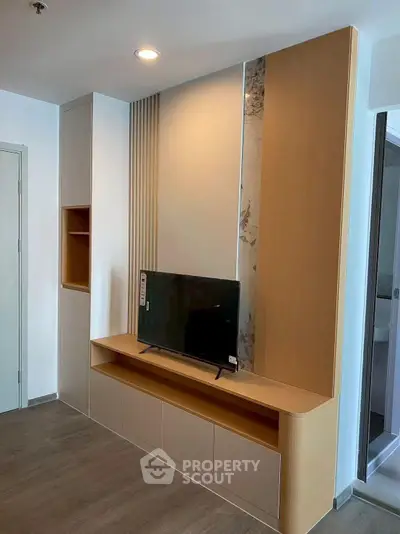 Modern living room with sleek TV unit and stylish wall paneling