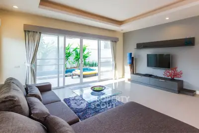Spacious living room with pool view and modern decor
