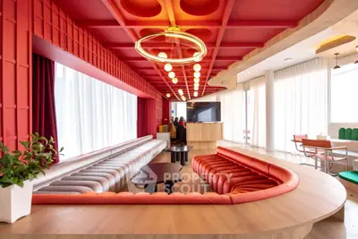 Stunning modern living room with vibrant red accents and unique ceiling design.