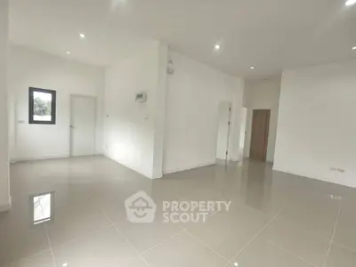 Spacious modern living room with glossy tiled floors and minimalist design