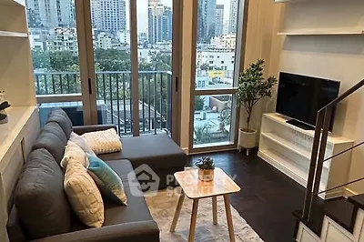 Modern living room with city view, cozy sofa, and stylish decor in urban apartment.