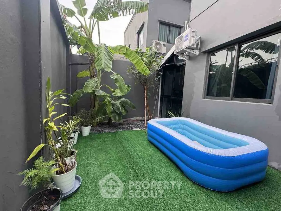 Charming outdoor garden with inflatable pool and lush greenery