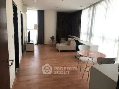 Spacious living room with modern furniture and large windows