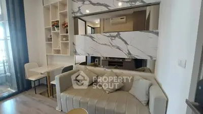 Modern living room with stylish marble accents and cozy seating area