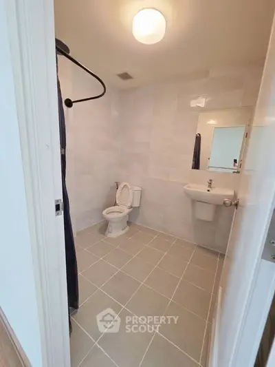 Spacious modern bathroom with sleek tile design and contemporary fixtures.