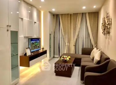 Elegant living room with modern furniture and ambient lighting, perfect for cozy evenings.