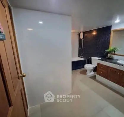 Spacious modern bathroom with bathtub and elegant fixtures