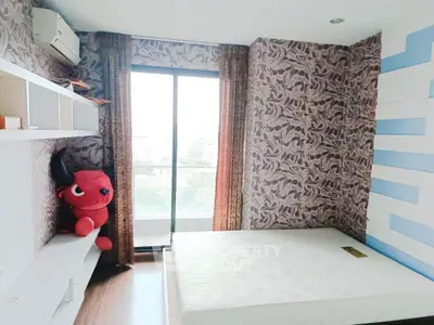Charming bedroom with unique wallpaper and large window offering natural light and city views.