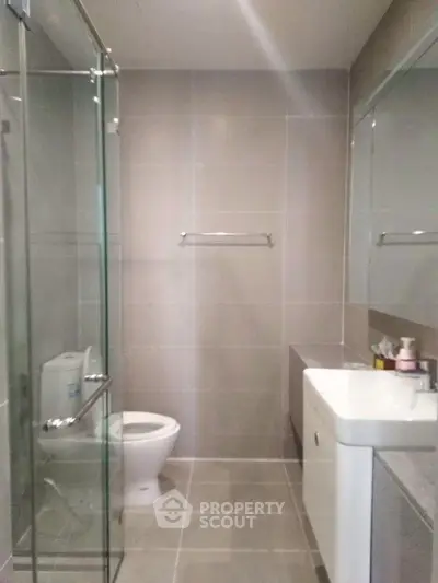 Modern bathroom with glass shower and sleek fixtures