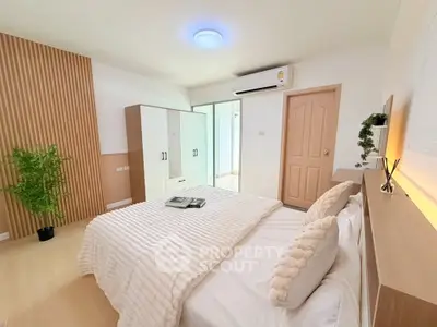 Modern bedroom with stylish decor and ample natural light