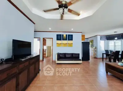 Spacious living room with modern ceiling fan and stylish decor