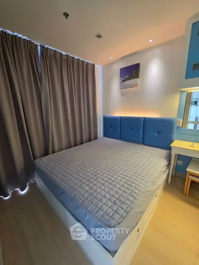 Modern bedroom with stylish blue headboard and cozy lighting
