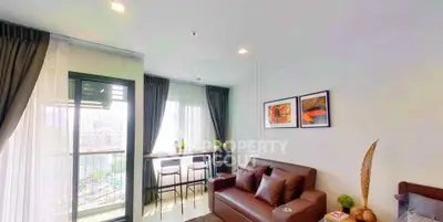Modern living room with city view, stylish decor, and natural light.