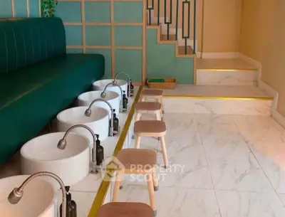 Modern spa interior with stylish seating and foot baths, perfect for relaxation and rejuvenation.