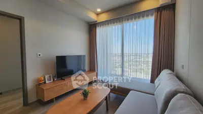 Modern living room with large window and stylish furniture