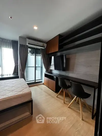 Modern bedroom with study area and balcony view in stylish apartment