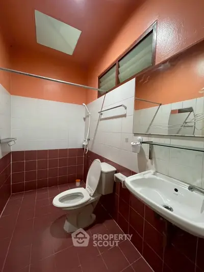Spacious bathroom with modern fixtures and vibrant tile design