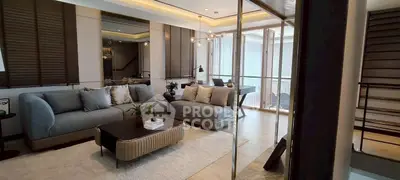 Luxurious modern living room with elegant decor and large windows for natural light.