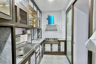 Modern kitchen with sleek cabinetry and gas stove in compact layout