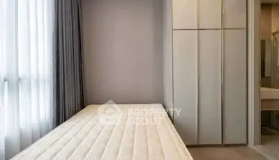 Minimalist bedroom with large window and built-in wardrobe