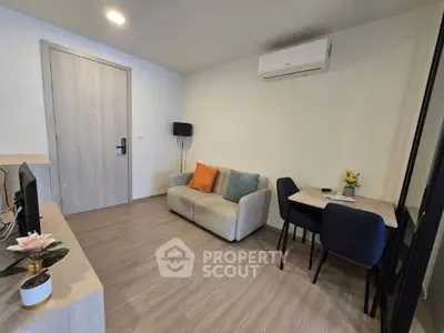 Modern living room with cozy sofa, dining table, and air conditioning in a stylish apartment.