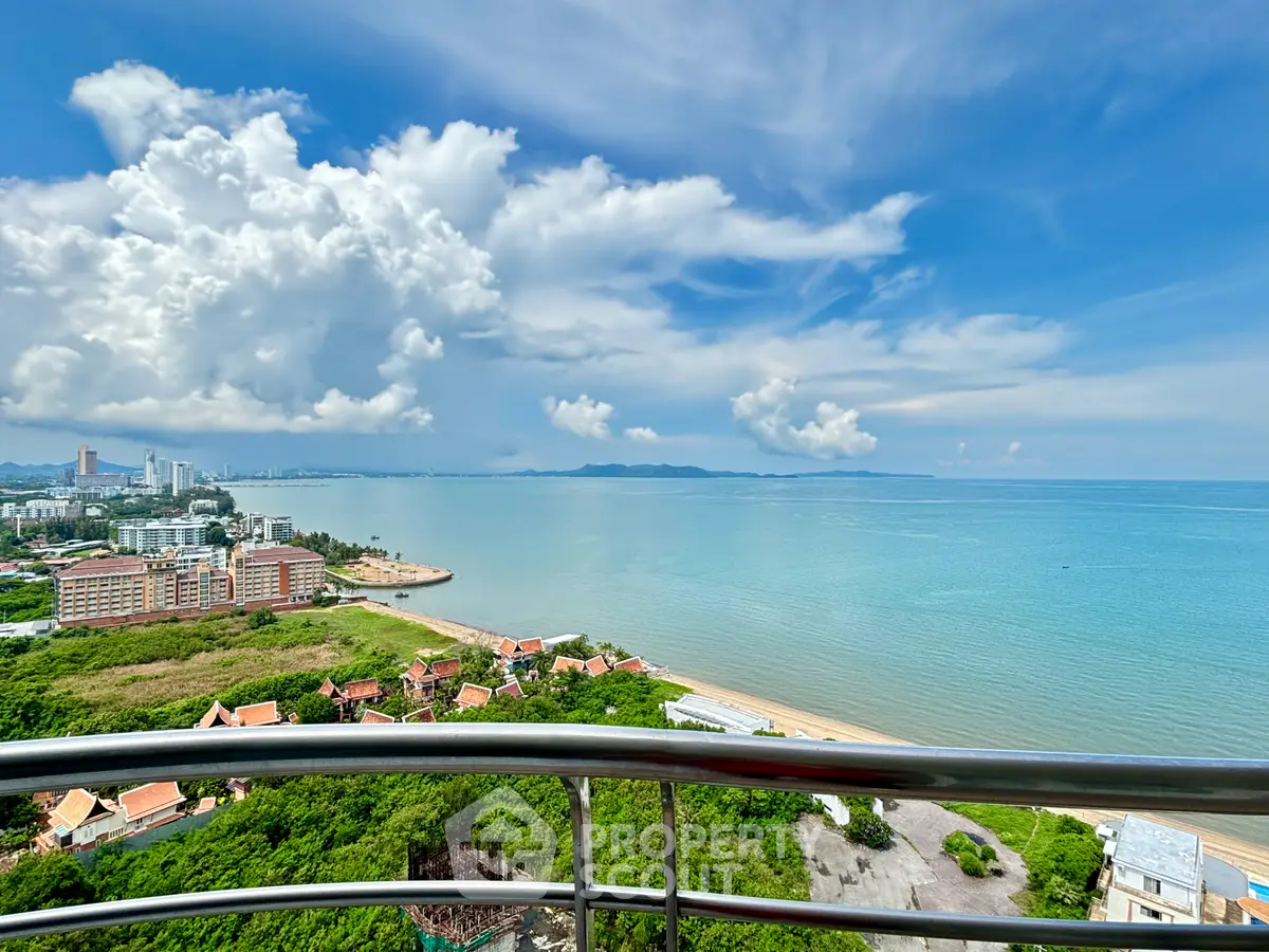 Stunning ocean view from high-rise balcony overlooking city and coastline