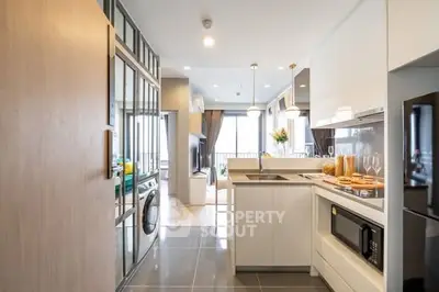 Modern open-layout kitchen with sleek appliances and bright living area view.