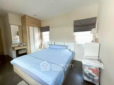 Cozy bedroom with modern furnishings and ample natural light