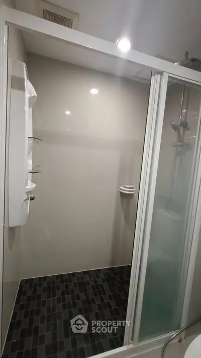 Modern bathroom with sleek shower enclosure and stylish tile flooring