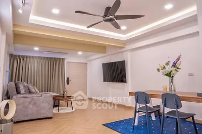 Spacious modern living room with stylish decor and ceiling fan