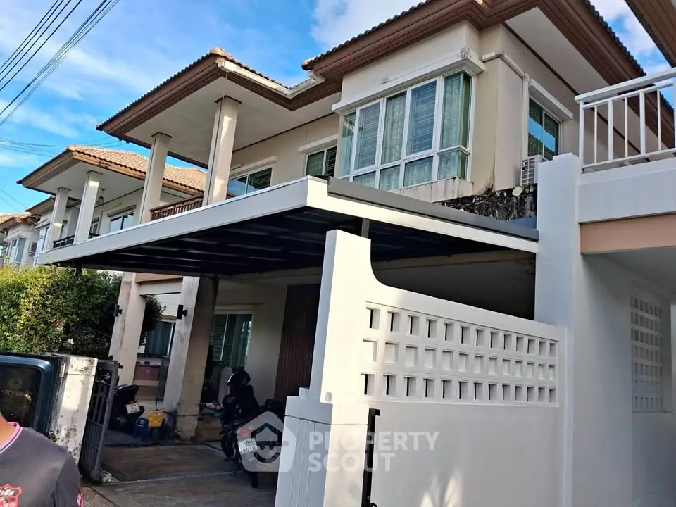 Charming two-story house with covered parking and modern design in a serene neighborhood.